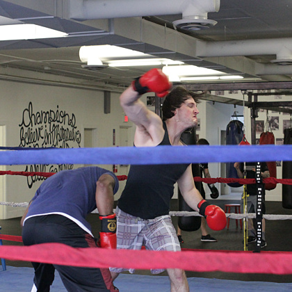 Practicing a fight sequence with the gloves on and in the ring.  Practice makes perfect, and also costs time, money and commitment!