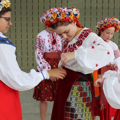 The Ukrainian dancers help Rebecca connect with her roots by providing dance clothing to help her learn to honor her culture with dance.