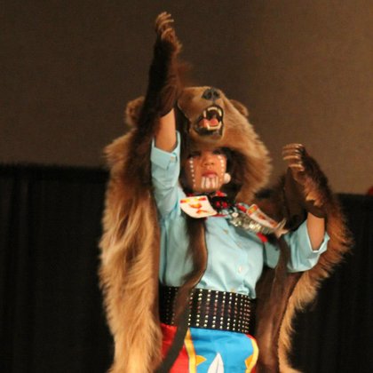 Laura Grizzlypaws performs a traditional dance with a grizzly bear skin.