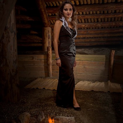 Model Tanya Pellett stands in a traditional Pithouse in a Linda Kay Peters design from Ringing Bell Robes in Hope BC.