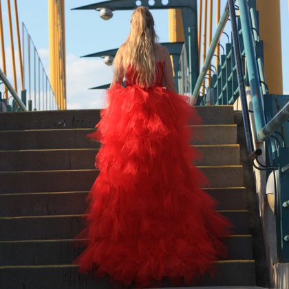 Model Dianna Flintoff wearings a red dress in honor of MMIWG.