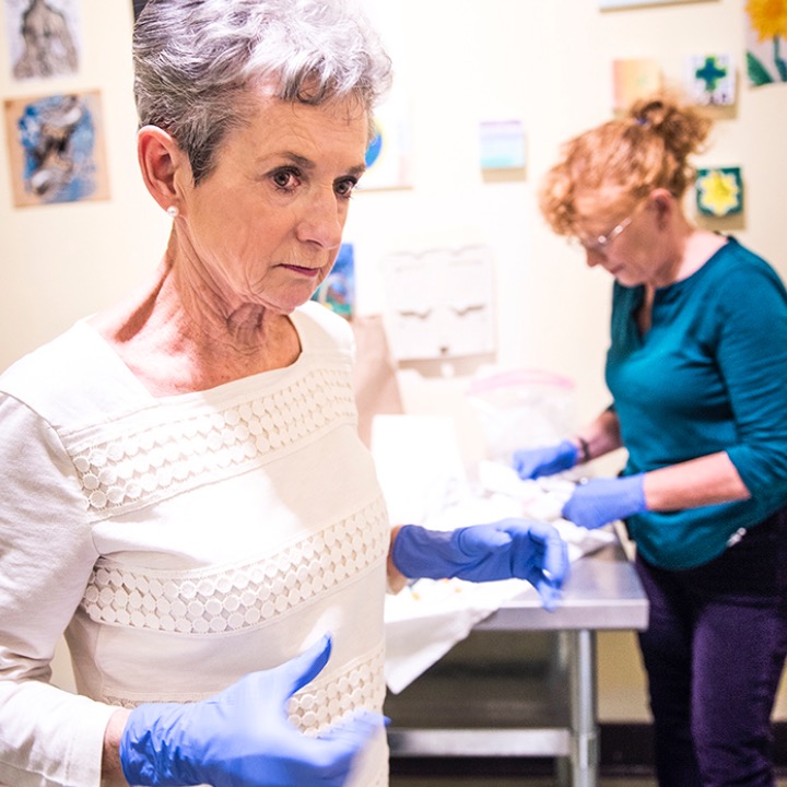 Without nursing support from Evanna Brennan and Susan Giles, their patients would suffer greatly, possibly even die, from a malady called venous sclerosis. Common to injection drug users and caused by dirty needles, this condition is characterized by festering ulcers. Brennan and Giles clean and rebandage these wounds on a regular basis, ensuring the patient doesn’t develop further infections in other parts of the body that travel from these suppurative injuries. 